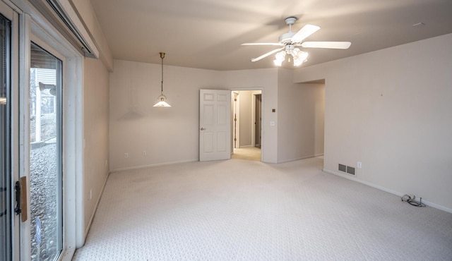 unfurnished room featuring light carpet and ceiling fan