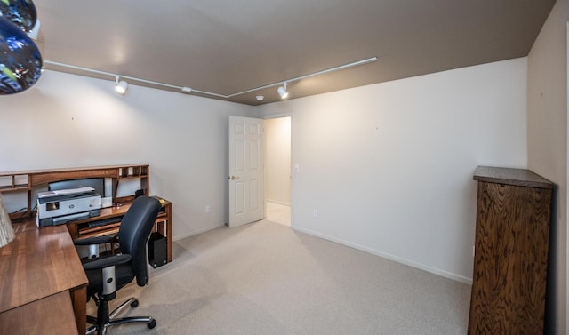 home office with light carpet and track lighting