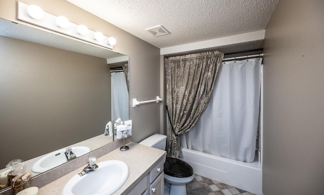 full bathroom featuring vanity, toilet, shower / bath combo with shower curtain, and a textured ceiling