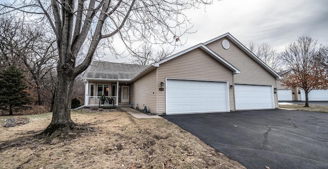 single story home featuring a porch and a garage