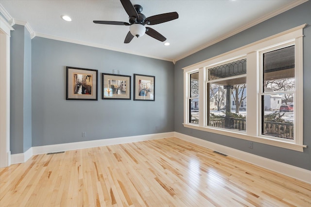 spare room featuring crown molding and baseboards