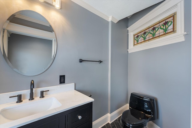 bathroom with vanity, baseboards, and a textured ceiling