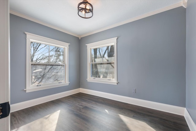 empty room with dark wood-style floors, crown molding, baseboards, and an inviting chandelier