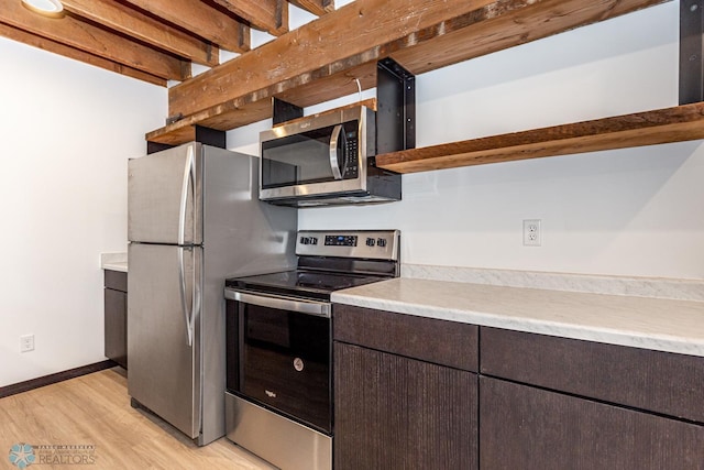 kitchen with light wood-type flooring, stainless steel appliances, and dark brown cabinetry