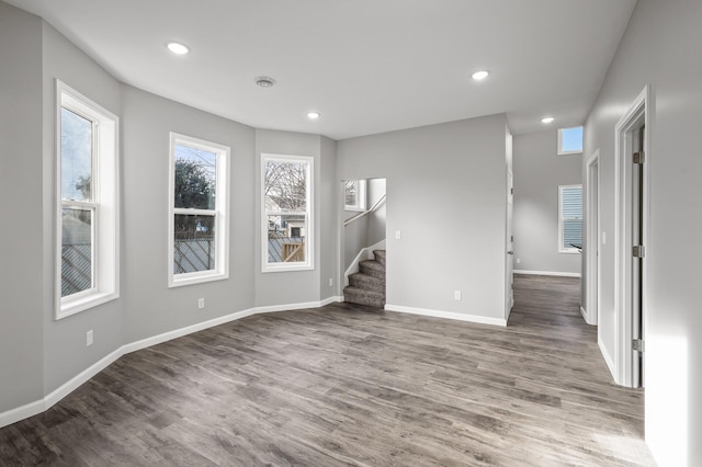 unfurnished living room featuring dark wood-type flooring