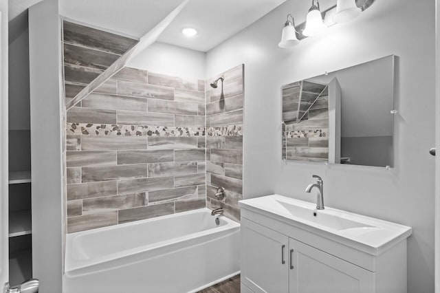 bathroom with vanity and tiled shower / bath combo