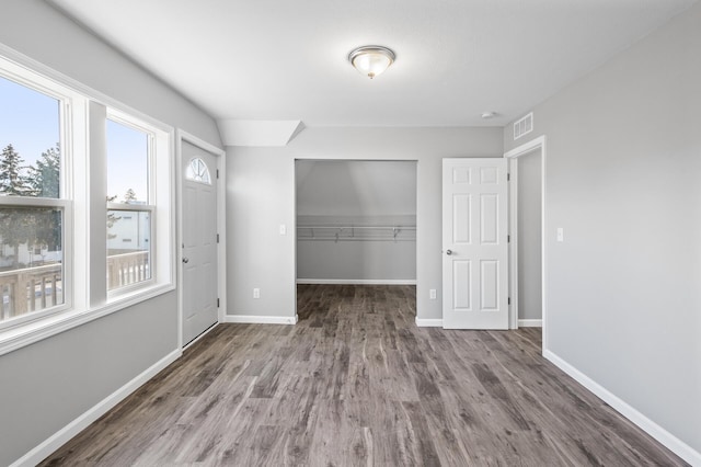 empty room with wood-type flooring and plenty of natural light