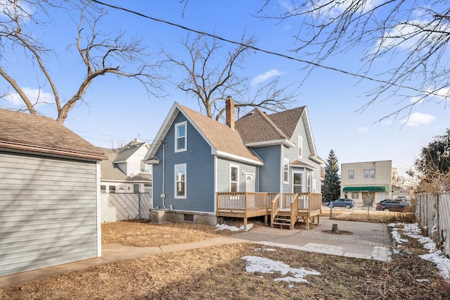 back of house featuring a deck and central AC