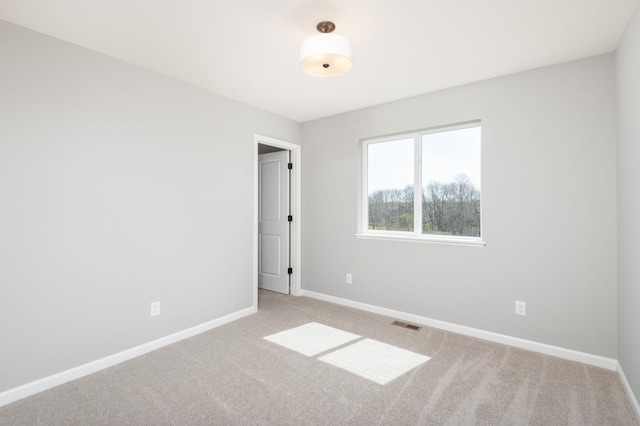 unfurnished room featuring carpet