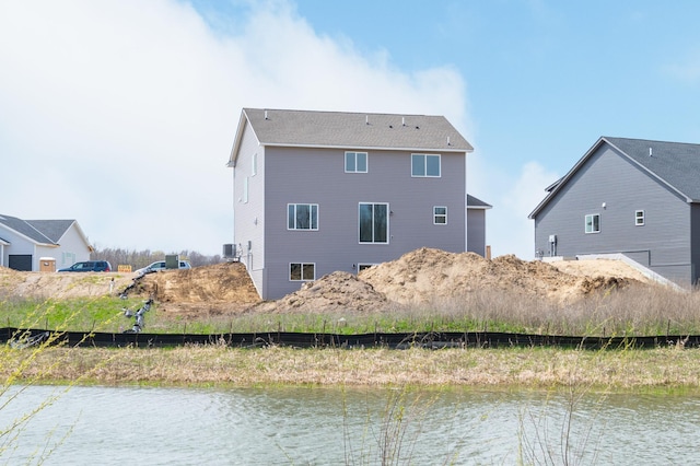 back of house with a water view and cooling unit