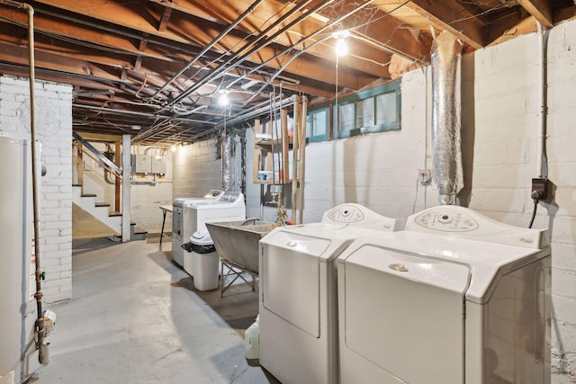 laundry area featuring gas water heater and washer and dryer