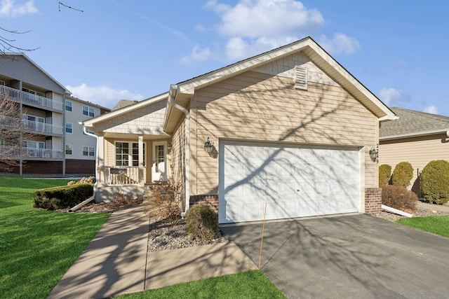 view of front of house featuring a porch, a garage, and a front lawn