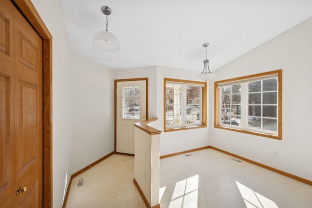 unfurnished dining area featuring lofted ceiling