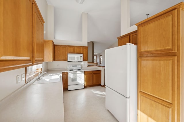 kitchen with vaulted ceiling, white appliances, and sink