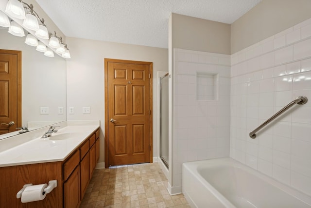 bathroom featuring vanity, independent shower and bath, and a textured ceiling