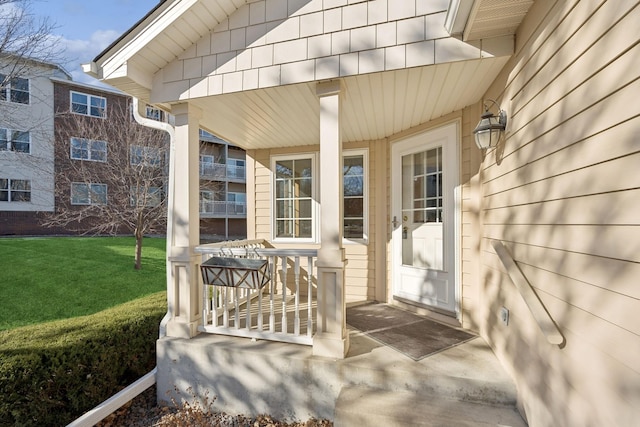 view of exterior entry featuring a lawn