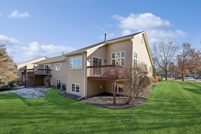 back of house featuring cooling unit, a deck, and a lawn