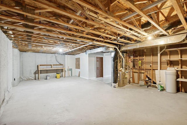 unfinished basement featuring heating unit