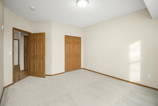 unfurnished bedroom with carpet floors and a closet