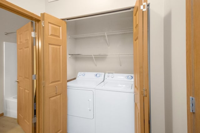 clothes washing area featuring washing machine and dryer