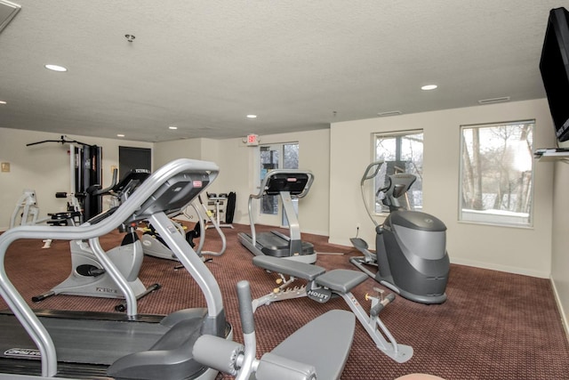 exercise room featuring a textured ceiling