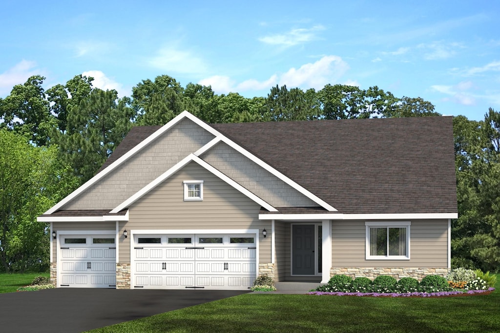 1003 Mulberry Ave NE, Montgomery, MN 56069 - craftsman house featuring a front lawn and a garage