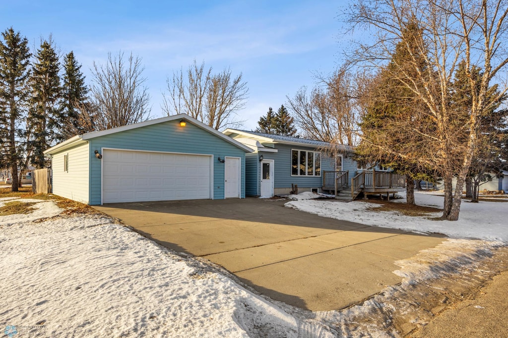 view of front of property with a deck and a garage