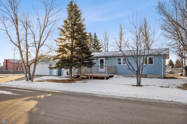 view of front of home with a garage and a wooden deck