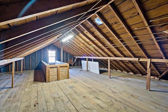 unfinished attic featuring an upstairs landing