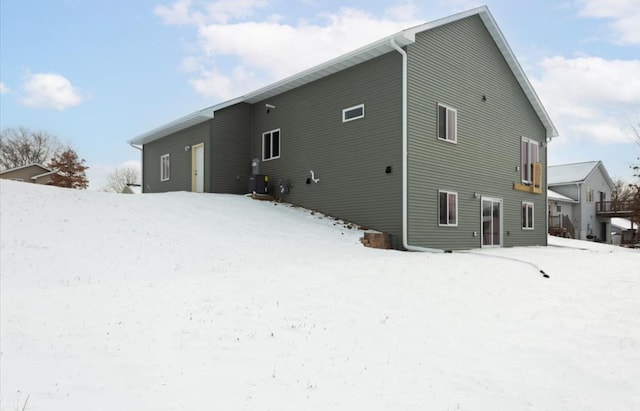 view of snow covered back of property