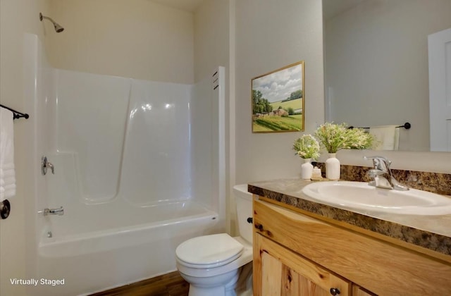 full bathroom featuring vanity, toilet, and washtub / shower combination