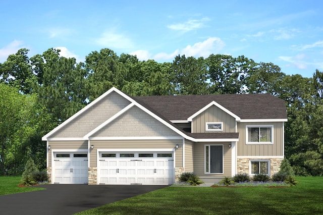 view of front of home with a front yard and a garage