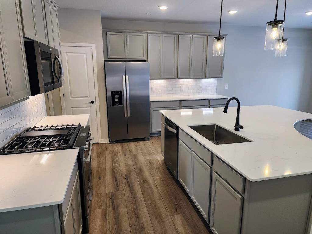 kitchen with sink, gray cabinets, and stainless steel appliances