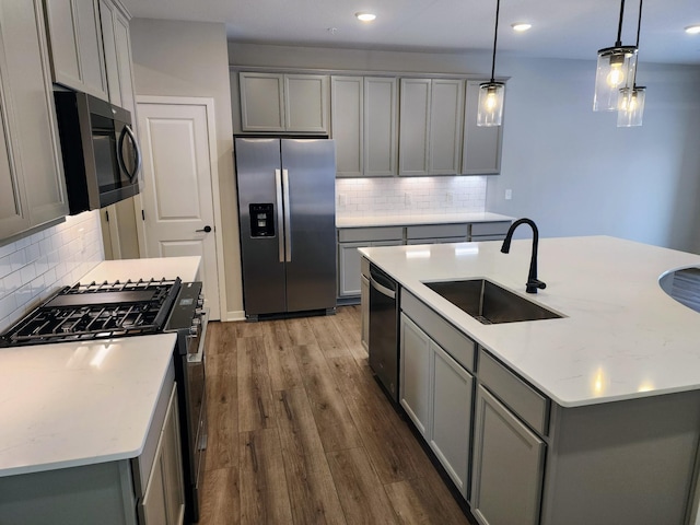 kitchen with sink, gray cabinets, and stainless steel appliances