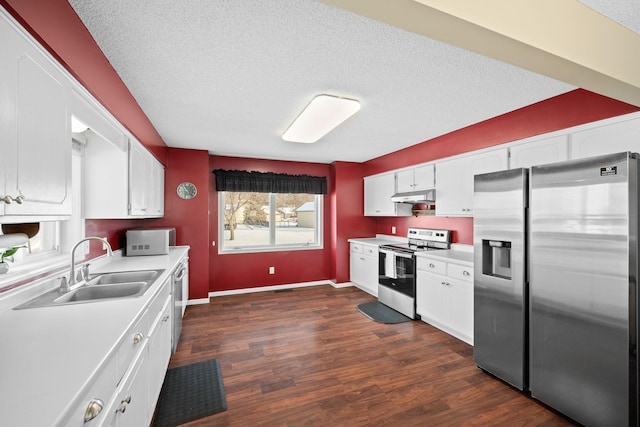 kitchen featuring stainless steel appliances, dark wood-type flooring, a textured ceiling, white cabinets, and sink