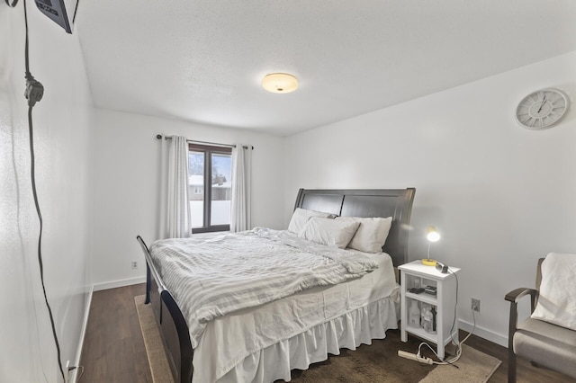 bedroom with dark wood-type flooring