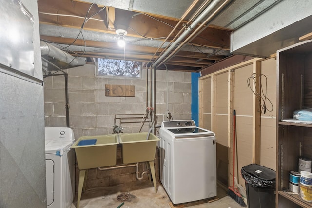 washroom with washer and dryer and sink