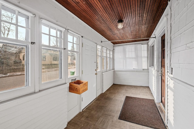 unfurnished sunroom featuring wooden ceiling