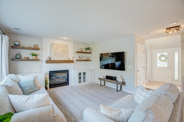 living room with a large fireplace and light carpet