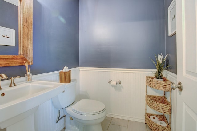 bathroom with tile patterned floors, toilet, and sink