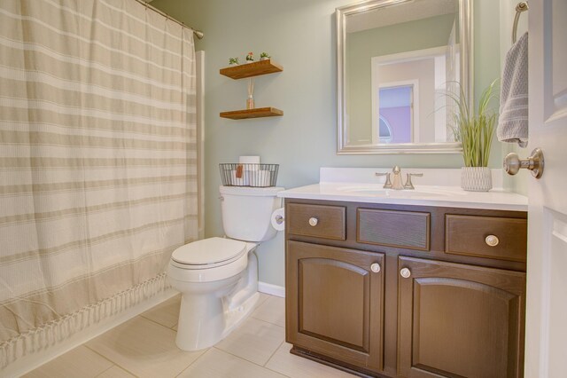 bathroom with vanity, toilet, and tile patterned flooring