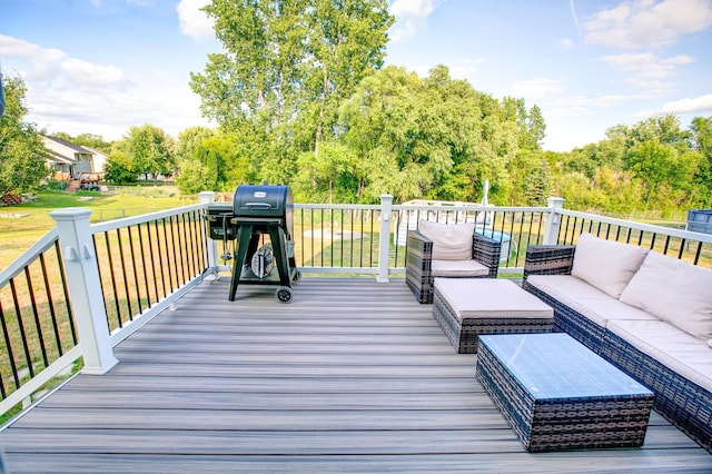 wooden terrace featuring a grill, an outdoor living space, and a lawn