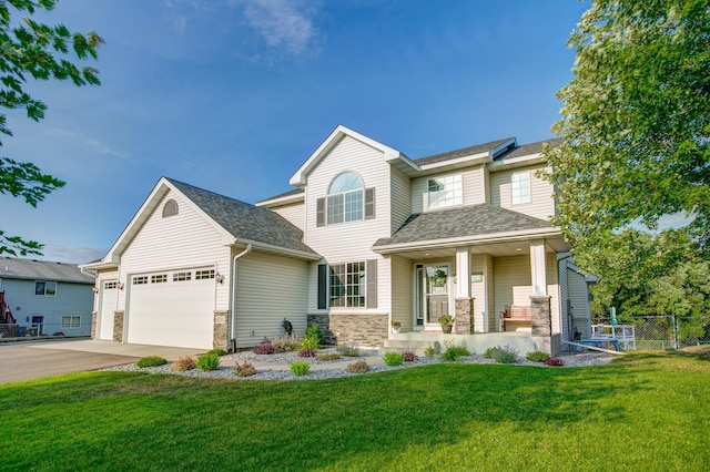 craftsman inspired home featuring a porch, a garage, and a front yard