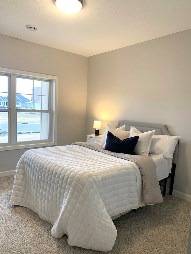 carpeted bedroom featuring a textured ceiling