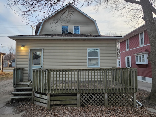 rear view of house featuring a wooden deck