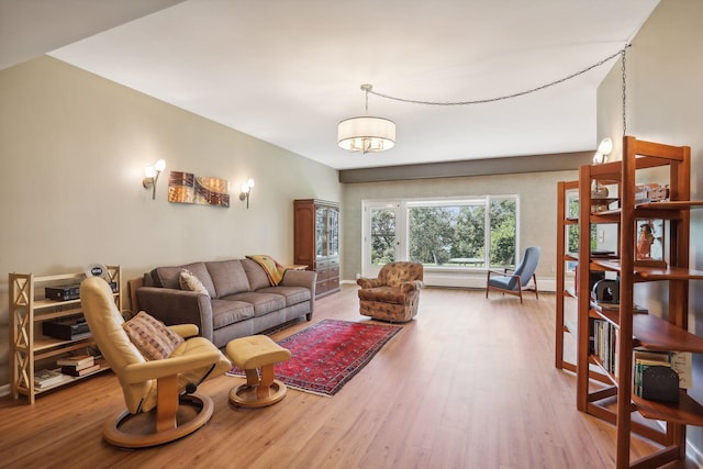 living room with wood-type flooring and an inviting chandelier