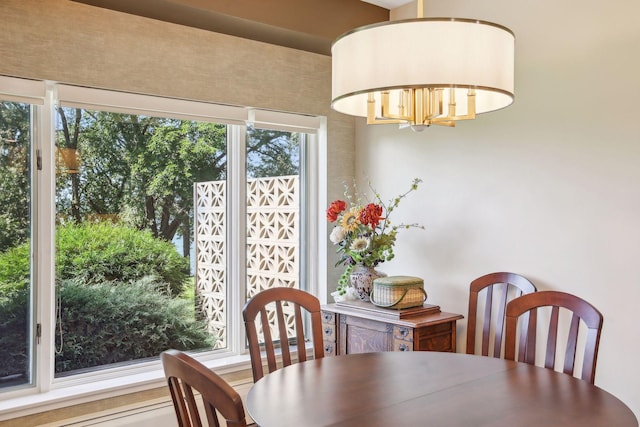 dining room with plenty of natural light and a notable chandelier