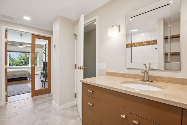 bathroom featuring ceiling fan, tile patterned flooring, vanity, and walk in shower