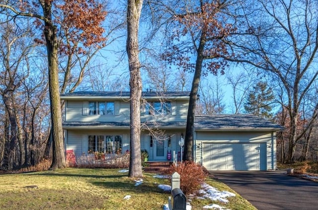 view of front of property with a garage and a front yard