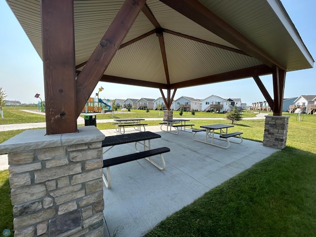 view of community with a playground, a patio area, a gazebo, and a lawn